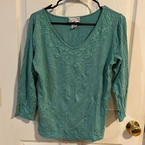 I meant long sleeve T-shirt with embroidery with beads around the neck